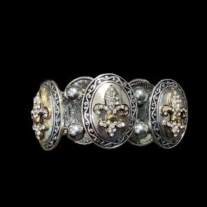 Fleur de lis silver and gold stretch bracelet. Excellent condition.